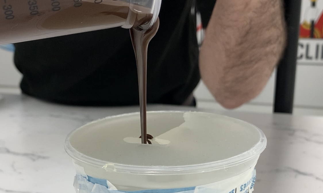 Pouring chocolate into the Platsil Gel 25 mould.