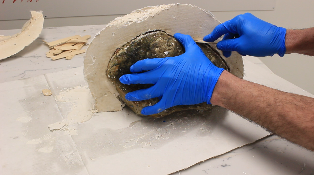 Releasing the second half of the mould from the rock. 